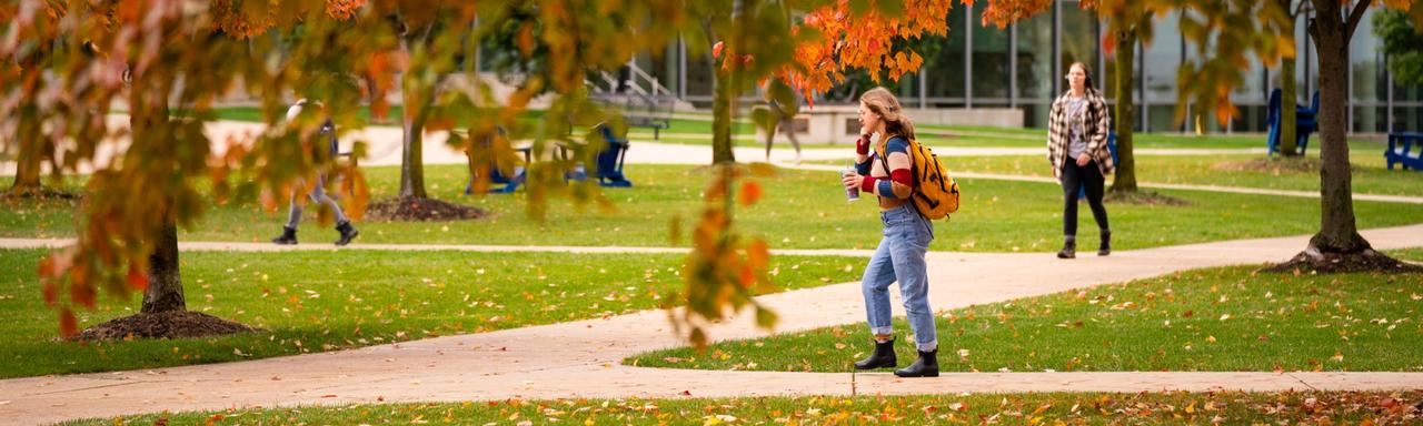 Student walking during the fall